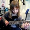 8 year old The Mini Band guitarist Zoe Thomson working on Stratosphere by Stratovarius. - 8-årig guitar-gudinde