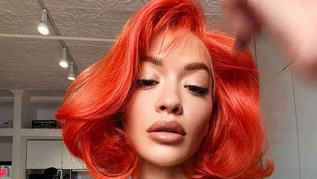 Rita Ora overlader næsten intet til fantasien: Kun iført festhat og rød paryk